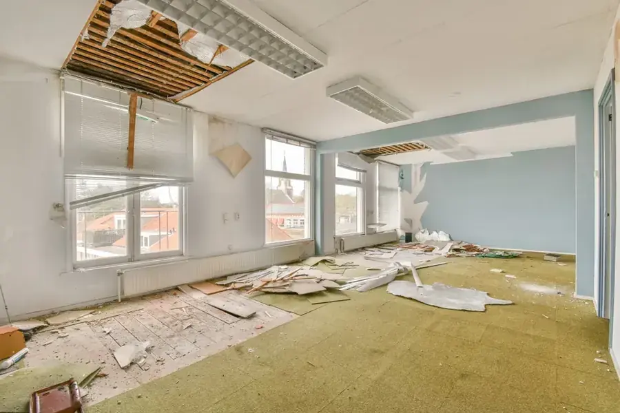Water-damaged ceiling opened up after a leak from above in a Natick home